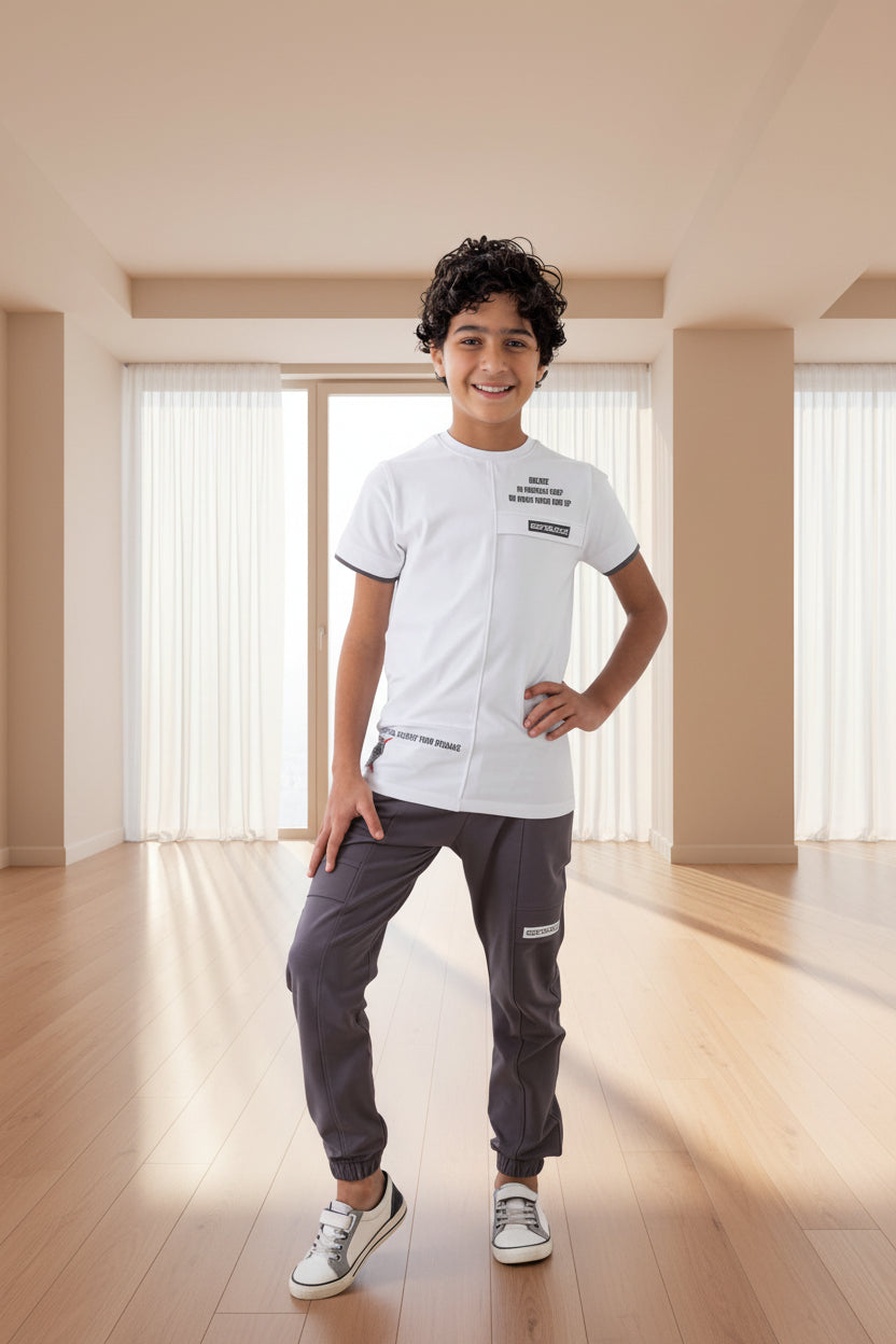 Child wearing a white t-shirt and gray pants with Rama Kids Wear branding.