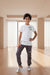 Child wearing a white t-shirt and gray pants with Rama Kids Wear branding.