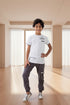 Child wearing a white t-shirt and gray pants with Rama Kids Wear branding.