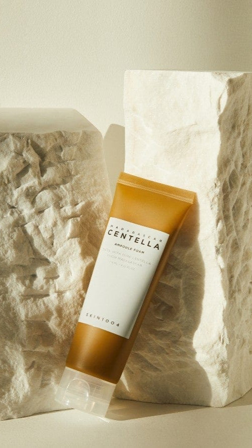 Tube of Centella Asiatica cream on a textured stone background