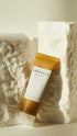 Tube of Centella Asiatica cream on a textured stone background